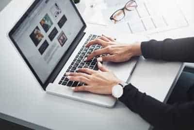 Woman’s hands typing on laptop – custom website design and SEO work for Helena small businesses